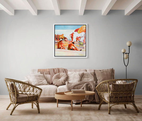 Living room with a beige sofa, wicker chairs, and a beach-themed painting on the wall.